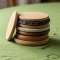 A stack of round coasters is arranged on a green fabric surface. The coasters are Royalty Free Stock Photo