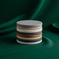 A stack of round coasters made from various materials and colors sits against a dark Royalty Free Stock Photo
