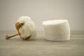 Stack of round cotton pads and natural cotton boll