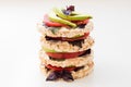Stack of round crispbreads with cheese, tomatoes, avocado and basil Royalty Free Stock Photo