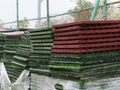 Stack of rubber floor tile mats and artificial turf grass rug tiles for elastic safety flooring. Eco safety surfacing mats are a Royalty Free Stock Photo