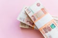 Stack of 5000 rubles packs isolated on pink. The concept of wealth, profits, business and finance. Stack money in the