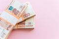 Stack of 5000 rubles packs isolated on pink. The concept of wealth, profits, business and finance. Stack money in the
