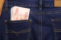 A stack of Russian five-thousandth ruble bills in a pocket of blue jeans. Money in your pocket, cash. Royalty Free Stock Photo