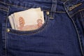 A stack of Russian five-thousandth ruble bills in a pocket of blue jeans. Money in your pocket, cash. Travel concept