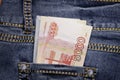 A stack of Russian five-thousandth ruble bills in a pocket of blue jeans. Money in your pocket, cash. Royalty Free Stock Photo
