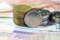 Stack of russian roubles coins on the banknotes background closeup Royalty Free Stock Photo