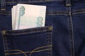 A stack of Russian thousand-ruble bills in a pocket of blue jeans. Money in your pocket, cash. Travel concept Royalty Free Stock Photo