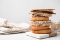 Stack of rye crispbreads, rice cakes and rusks on white table, space for text Royalty Free Stock Photo