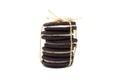 Stack of sandwich chocolate cookies filling a sweet cream biscuits with rope tied on white