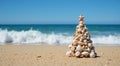 Stack of scallop shells with coral and stone pebbles arranged to resemble a Christmas tree