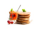 Stack of scotch pancakes with wild apples jam isolated on white