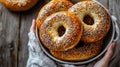 Stack of Seeded Bagels in Ceramic Bowl Held Over Wood Background Royalty Free Stock Photo