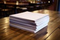 stack of seminar booklets on a wooden table