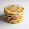 A stack of seven round flatbreads is displayed on a white surface Royalty Free Stock Photo