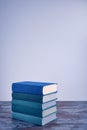 A stack of several books in fabric textured covers in beautiful emerald and blue colors. Royalty Free Stock Photo