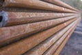 A stack of sheet pile elements in close-up along the spring on a construction site with selective focus