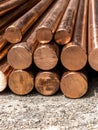 A stack of shiny copper rods on the ground. Royalty Free Stock Photo