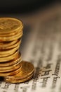 Stack Of Shiny Gold Coins On Newspaper Background Royalty Free Stock Photo