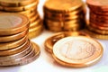 Stack of shiny white and golden Euro coins of different value on white background, finances, investment, stock, savings