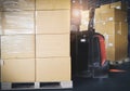 Stack of shipment boxes with electric forklift pallet jack at the warehouse. Cargo export & shipping warehousing. Royalty Free Stock Photo