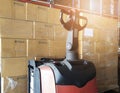 Stack of shipment cardboard boxes with electric forklift pallet jack at warehouse storage. Cargo export & shipping warehousing Royalty Free Stock Photo