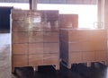 Stack of shipments boxes on wooden pallets. Interior of warehouse storage.