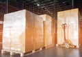 Stack of shipments boxes on wooden pallets. Interior of warehouse storage.