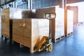 Stack of shipments boxes on wooden pallets. Interior of warehouse storage. Royalty Free Stock Photo