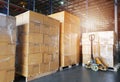 Stack of shipments boxes on wooden pallets. Interior of warehouse storage.