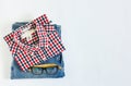 Stack of plaid shirt and blue jean with glasses on white background Royalty Free Stock Photo