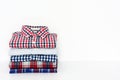 Stack of plaid shirts isolated on white background Royalty Free Stock Photo