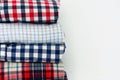 Close up stack of plaid shirts on white background Royalty Free Stock Photo