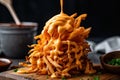 stack of shoestring fries drizzled with zesty buffalo sauce
