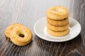 Stack of shortbreads in saucer and on wooden table Royalty Free Stock Photo