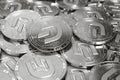 Stack of silver Dash coins with 2019 updated logo in blurry closeup. 3D rendering
