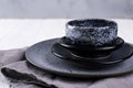 Stack of simple porcelain handmade gray and black plates and bowls