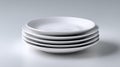 Stack of simple white dishes ready for serving food in a kitchen Royalty Free Stock Photo