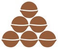 Stack of six brown macadamia nuts forming a pyramid against a white background Royalty Free Stock Photo