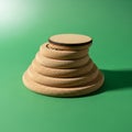 A stack of six round wooden discs is arranged on a flat surface with a green Royalty Free Stock Photo