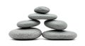 A stack of six smooth, flat, gray stones arranged in a pyramid-like structure against Royalty Free Stock Photo