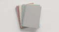 A stack of six spiral-bound notebooks is arranged on a white surface. Each notebook has a plain Royalty Free Stock Photo