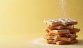 Stacked Waffles with Powdered Sugar on Yellow Background Royalty Free Stock Photo