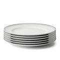 Stack of White Dinner Plates with Silver Rim Detail on White Background Royalty Free Stock Photo