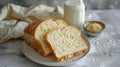 a stack of sliced brown bread on a plate alongside a milk bottle, set against a grey background for a sleek and simple Royalty Free Stock Photo