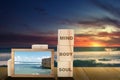Stack of small wooden cubes with the text of mind, body, and soul with a small chalkboard with a view of the blue sky on the beach Royalty Free Stock Photo
