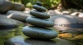 A stack of smooth, oval-shaped stones is balanced precariously on a larger stone in a Royalty Free Stock Photo