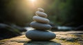 A stack of smooth, rounded stones balances precariously on each other, starting with larger stones Royalty Free Stock Photo