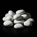 A stack of smooth, white pebbles sits against a dark background. The pebbles have a Royalty Free Stock Photo
