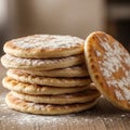 A stack of soft, round flatbreads dusted with flour rests on a wooden surface. The Royalty Free Stock Photo